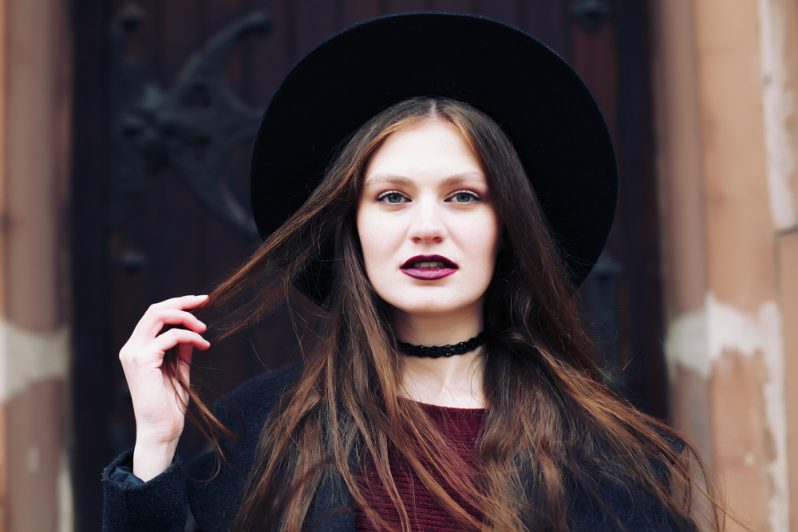 A woman wearing 1990s style fashion and makeup