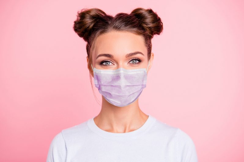 A woman wearing a colourful medical face mask