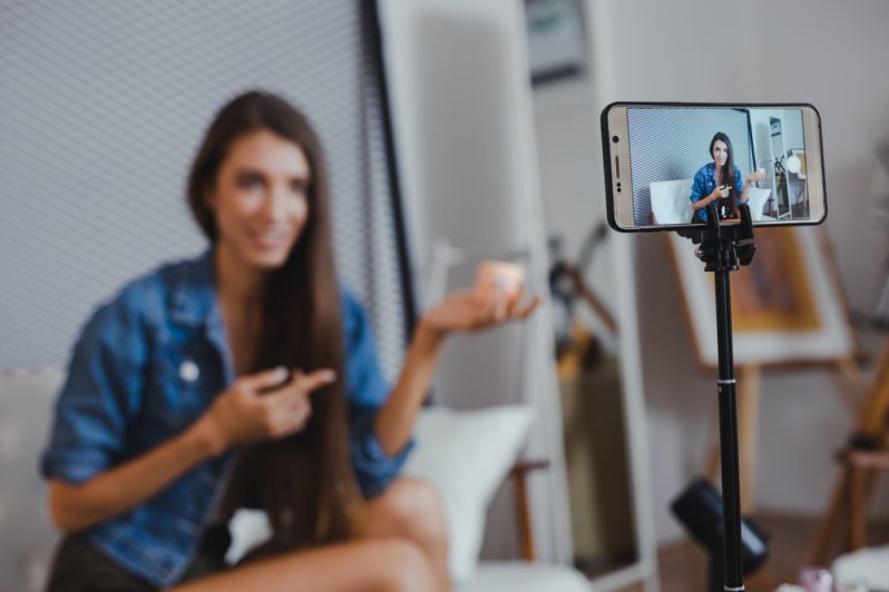 An online influencer talking to a camera