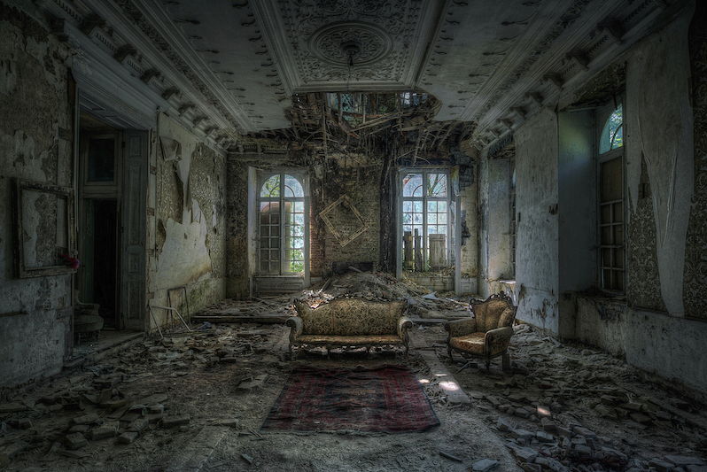 The inside of a dusty abandoned mansion